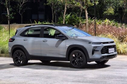 Chevrolet Sonic 2027 branco, vista frontal 3/4 em estúdio, carroceria elevada e assinatura visual da Chevrolet