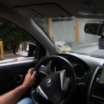 Fila de carros compactos usados por motoristas de aplicativo em grande cidade brasileira, foto frontal horizontal