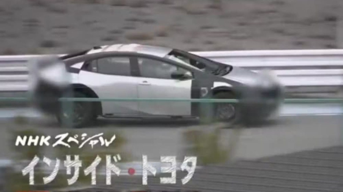 Protótipo camuflado da nova geração do Toyota Corolla em estúdio, vista frontal e lateral, destacando o para-brisa inclinado, formato da carroceria e traseira curta, landscape