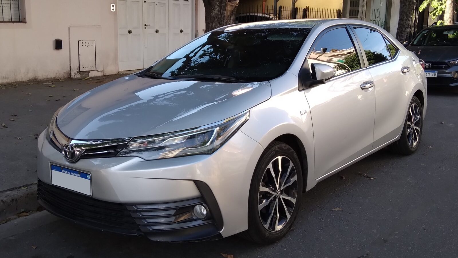 Toyota Corolla prata de 11ª geração reestilizado, fabricado no Brasil, em vista frontal de três quartos