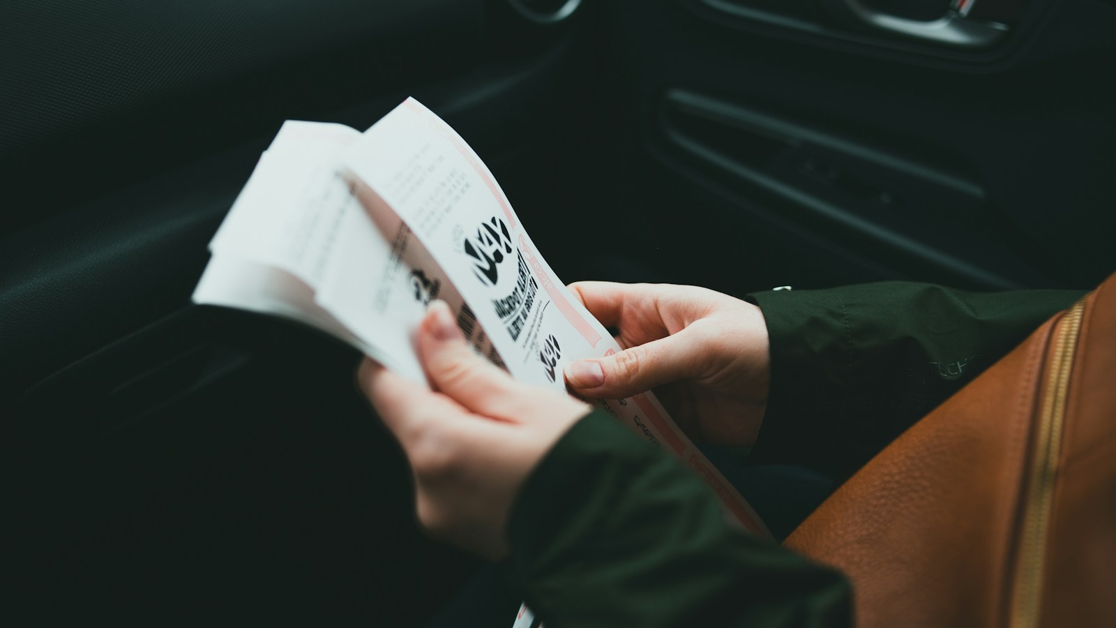 Motorista confere papéis dentro do carro, como o documento do licenciamento em Minas Gerais